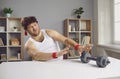 Funny lazy chubby man pushing away dumbbells unwilling to start sports workouts at gym
