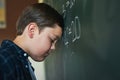 I dont know how to do this. a young boy standing and feeling depressed while trying to answer a question on the Royalty Free Stock Photo