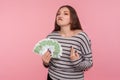 I earned myself! Portrait of haughty young woman in striped sweatshirt holding euro banknotes, looking with arrogance