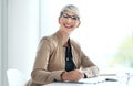 I enjoy my busy day in the office. Portrait of a young businesswoman writing notes in an office. Royalty Free Stock Photo