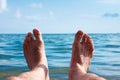 I enjoy the sea. A man lies on the beach opposite the sea Royalty Free Stock Photo