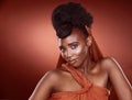 I feel like a queen in this attire. Cropped portrait of an attractive young woman posing in studio against a red Royalty Free Stock Photo