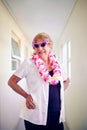 I feel young again. Shot of a carefree elderly woman wearing pink glasses and posing inside of a building. Royalty Free Stock Photo