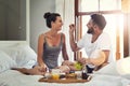 I fell in love with his sweet romantic side. a happy young couple enjoying breakfast in bed together at home. Royalty Free Stock Photo