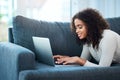 I finally have time to reply to those unread emails. a young woman using her laptop while relaxing at home. Royalty Free Stock Photo