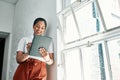 I found just what I need. a young businesswoman using a digital tablet in an office.