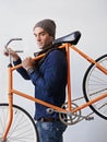 I go everywhere by bike. a trendy young man carrying his bicycle. Royalty Free Stock Photo