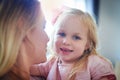 I got my cuteness from my momma. an adorable little girl bonding with her mother at home.