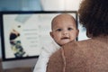 When I grow up I wanna be just like mom. a young woman using a computer while caring for her adorable baby girl at home.