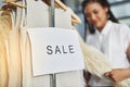 I had to - it was on sale. a woman looking at dresses on a rail with a sign that reads sale. Royalty Free Stock Photo
