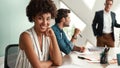 I am happy to work here Young afro american woman is looking at camera and smiling while her boss standing near Royalty Free Stock Photo