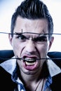 I hate social norms! Man screaming behind a barbed wire as symbol of  readiness to fight. Royalty Free Stock Photo