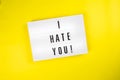 I Hate You! message on lightbox on yellow background isolated Top view, flat lay Royalty Free Stock Photo