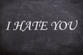 I hate you white stylish text with blackboard background. Royalty Free Stock Photo