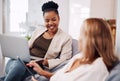 I have the best colleague. two attractive young businesswomen sitting in the office together and using technology during Royalty Free Stock Photo