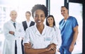 I have the best team behind me. Portrait of an attractive female doctor standing with her arms folded in the hospital Royalty Free Stock Photo