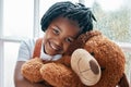 I have the cutest teddy in the world. Portrait of an adorable little girl holding a teddy bear at home.