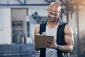 I have a day full of clients to train. a muscular young man writing notes on a clipboard while working in a gym. Royalty Free Stock Photo