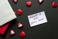 I have a dream. Love concept - valentine's day background. Red hearts and paper wit hand writing on black