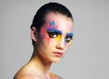 I have enough makeup, said no one ever. Studio shot of an attractive young woman with brightly colored makeup against a