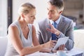 I have a few ideas that may help you. two colleagues working together at a desk. Royalty Free Stock Photo