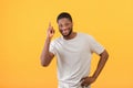I have idea. Inspired african american man raising finger up, standing over yellow studio background Royalty Free Stock Photo