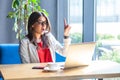 I have an idea. Portrait of surprised beautiful stylish brunette young woman in glasses sitting, looking at her laptop screen with Royalty Free Stock Photo