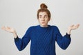 I have no idea, it was not my fault. Portrait of confused and troubled cute redhead woman in winter sweater shrugging