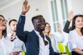 I have a question. Group of people sitting at the chairs in conference hall, raising their hands. Workshop at university. Business Royalty Free Stock Photo