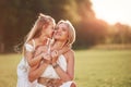 I have secret for you. Mother and daughter enjoying weekend together by walking outdoors in the field. Beautiful nature