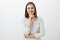 I have tell you something but shh. Portrait of friendly-looking enthusiastic charming young woman with short brown Royalty Free Stock Photo