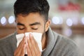 I have to get a diagnosis. Shot of a young man blowing his nose. Royalty Free Stock Photo