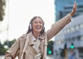 I hope this cab stops for me. Shot of a young businesswoman hailing a cab in town. Royalty Free Stock Photo