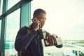 I hope I dont miss my flight. a young man checking the time in an airport. Royalty Free Stock Photo