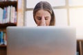 I hope I finish this assignment on time. a young woman looking stressed while sitting behind a laptop. Royalty Free Stock Photo