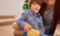 I hope its what wanted. a young boy opening a Christmas present with his mom. Royalty Free Stock Photo
