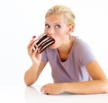 I hope no one sees me cheating - Dieting. Young woman stuffing her mouth full of chocolate cake. Royalty Free Stock Photo