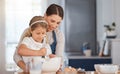 I hope it tastes as good as yours, mom. an adorable little girl assisting her mother while baking at home. Royalty Free Stock Photo