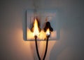 I hope youve got insurance. two plugs in a wall socket catching fire. Royalty Free Stock Photo