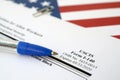 I-140 Immigrant petition for alien workers blank form lies on United States flag with blue pen from Department of Homeland