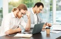 I just cant focus today. a young businessman looking stressed out while working on a laptop in an office with his