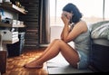 I just cant get over him. Full length shot of an attractive young woman looking depressed while sitting on the floor in Royalty Free Stock Photo