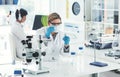 I just need a little bit of this liquid. an attractive young female scientist dropping some liquid into a beaker in a Royalty Free Stock Photo