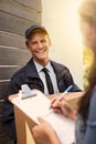 I just need your signature. a young man making a delivery to a woman at her home. Royalty Free Stock Photo