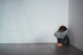 I just want to be alone. Shot of a depressed young woman sitting in a corner alone. Royalty Free Stock Photo