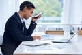 I just wanted to confirm a few of the numbers...a young businessman using a cellphone while going through paperwork in Royalty Free Stock Photo