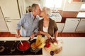 I kiss better than I cook. an affectionate couple preparing a meal in the kitchen. Royalty Free Stock Photo