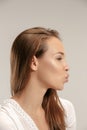 Portrait of attractive cute girl with kiss isolated over gray background Royalty Free Stock Photo