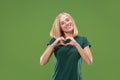 Portrait of attractive cute girl with kiss isolated over green background Royalty Free Stock Photo