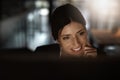 I like the look of that. a young businesswoman working online during a late night in a modern office. Royalty Free Stock Photo